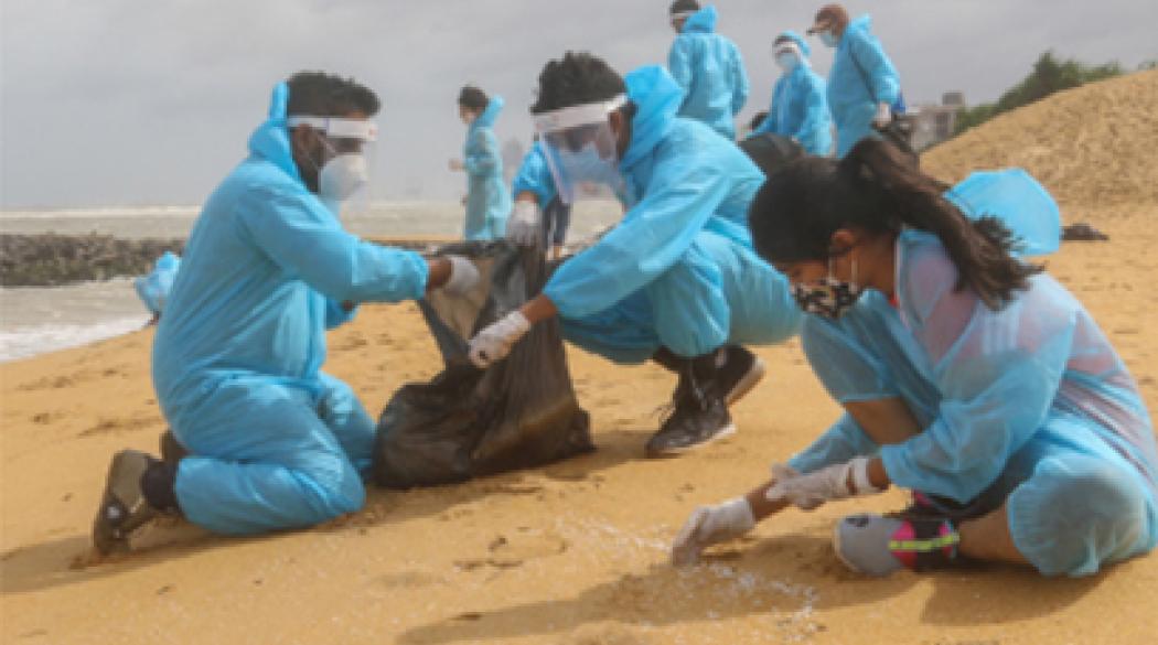 Staff cleaning up beach