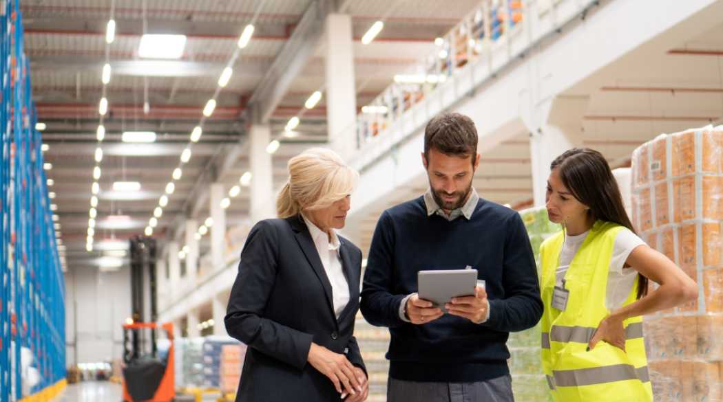 Coworkers collaborate around a tablet device