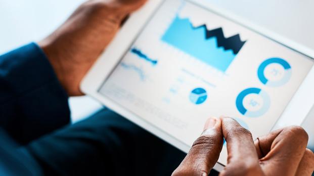 Man looking at a digital dashboard on an iPad