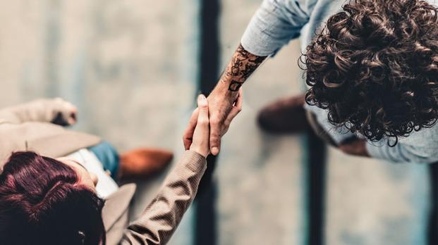 Business people shaking hands viewed from above