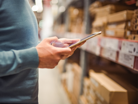 Person holding portable device to manage orders