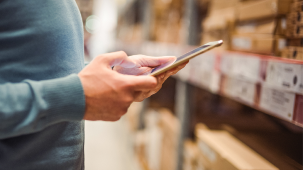 Person holding portable device to manage orders